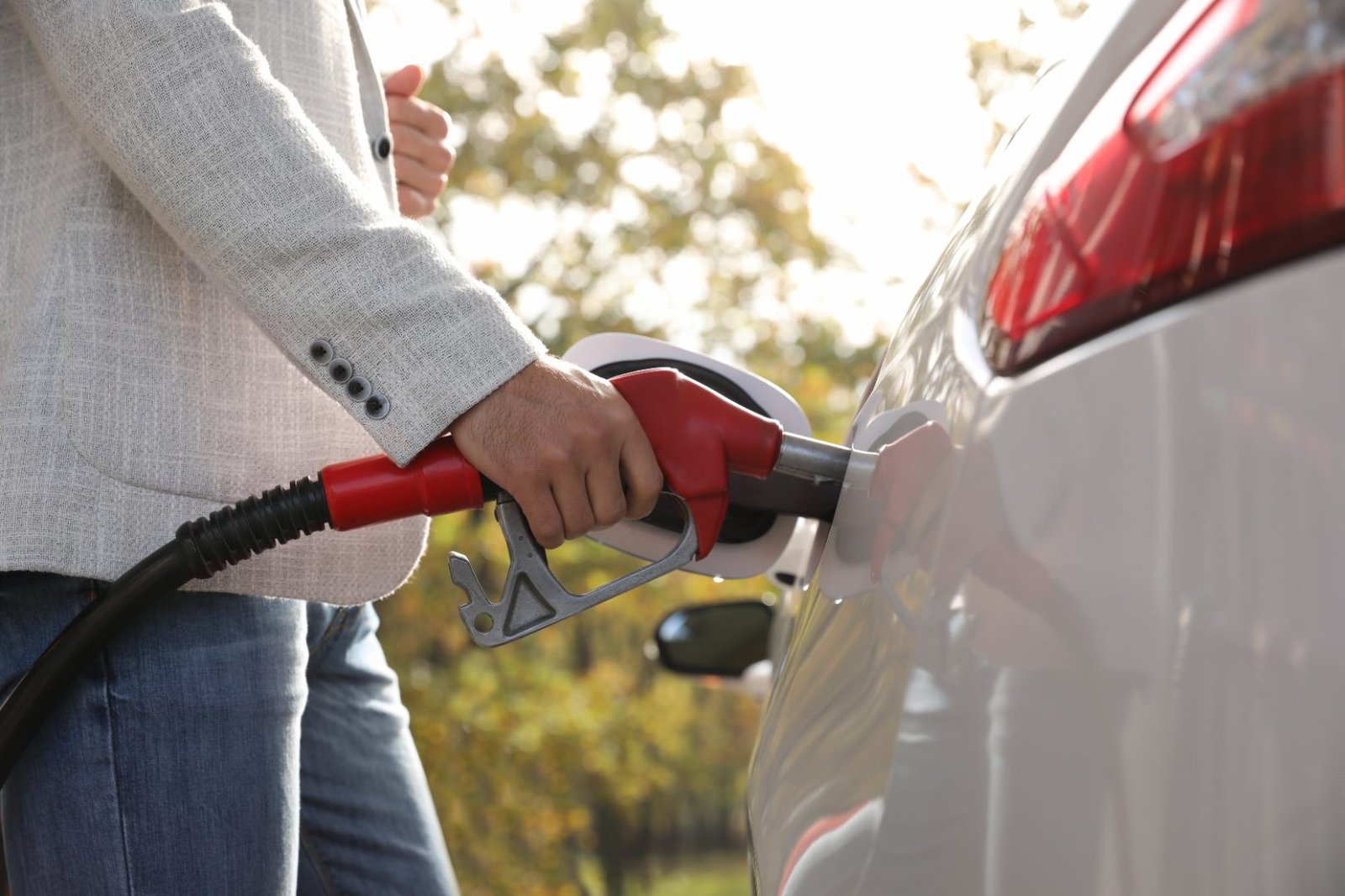 A person refueling a car at a gas station