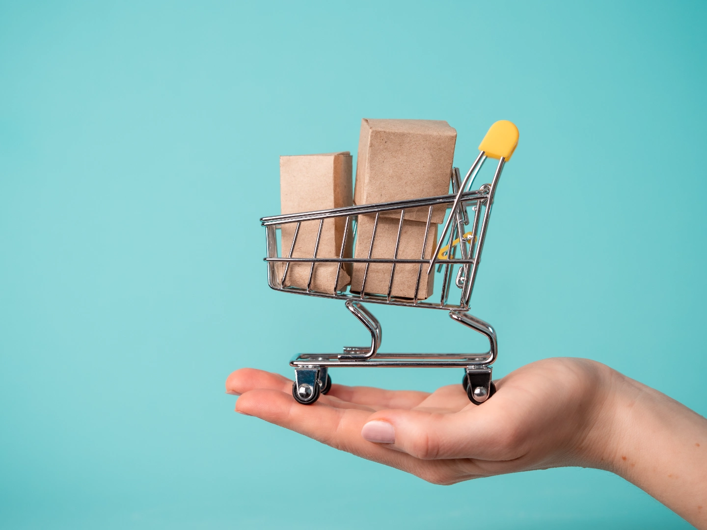 A small shopping cart with boxes representing online orders